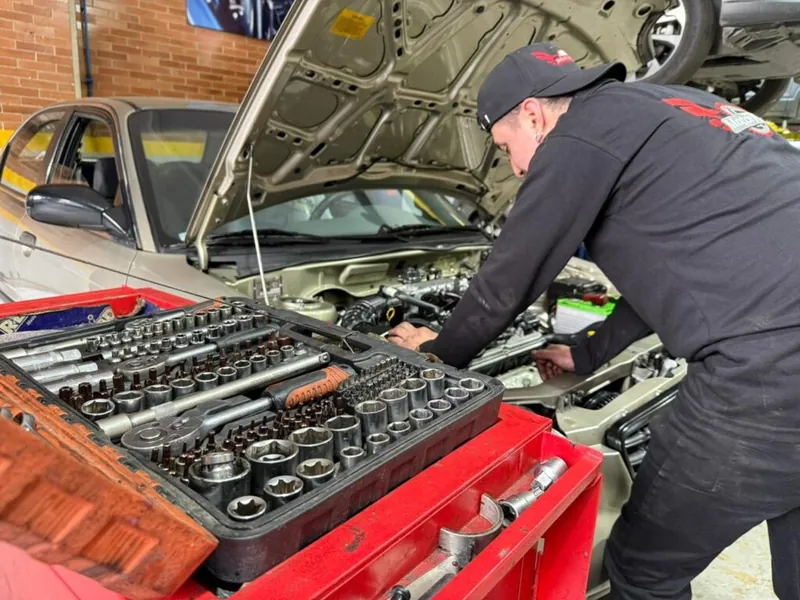 Técnico de MotorPro trabajando en el motor de un vehículo